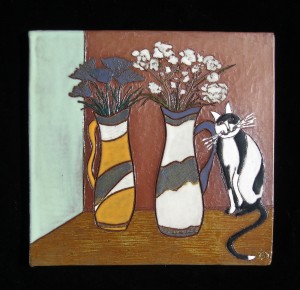 black and white cat with flower vases