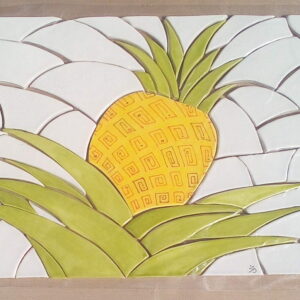 Handmade ceramic mosaic of a blue pineapple on white porcelain.